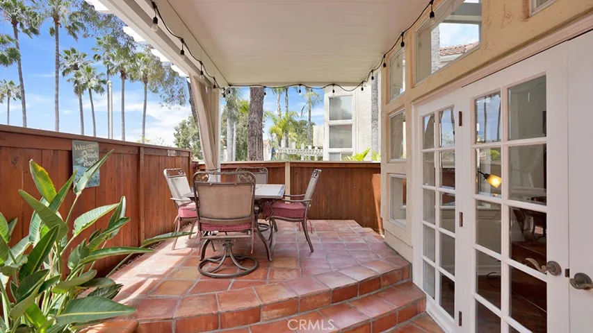 The elevated patio area has beautiful Spanish style flooring and overlooks an HOA greenbelt.