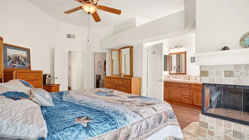 The primary bedroom has a gas fireplace, a walk-in closet and an ensuite bathroom.