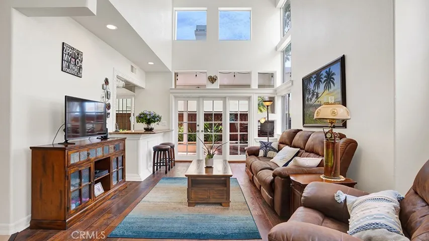 The living room features approximately 20ft ceilings and has plenty of natural light from all of the windows.