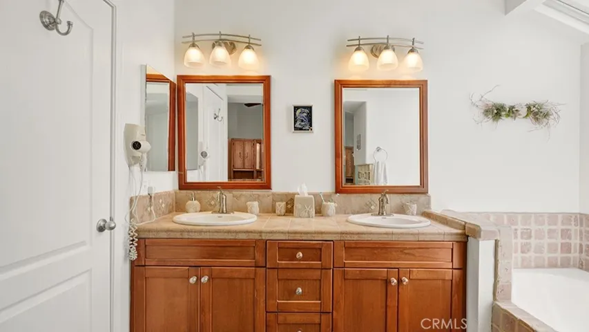 The primary bathroom has a dual sink vanity and a separate soaking tub.