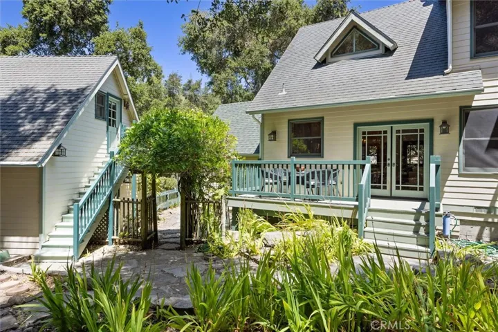 Backyard view to the stairway leading to studio apartment above garage