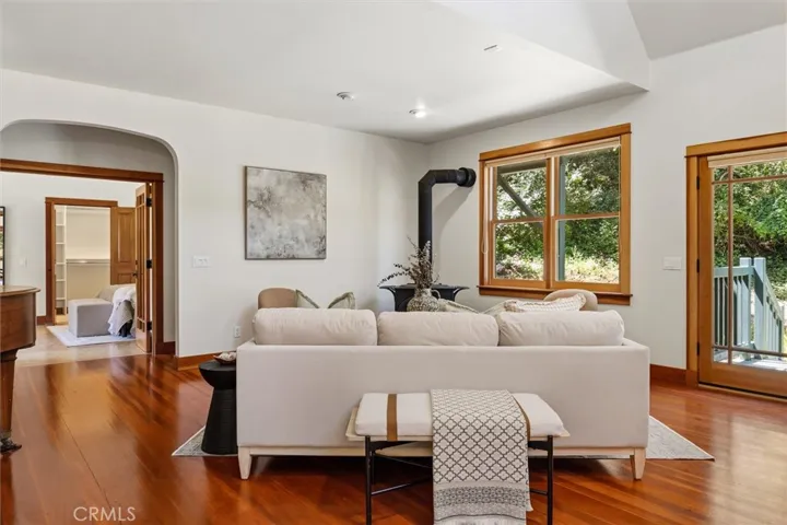 relax in the great room with woodstove and french doors to the tranquil back deck