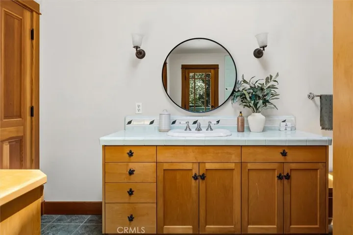 Wood vanity with tile counter- separate make up vanity on the left