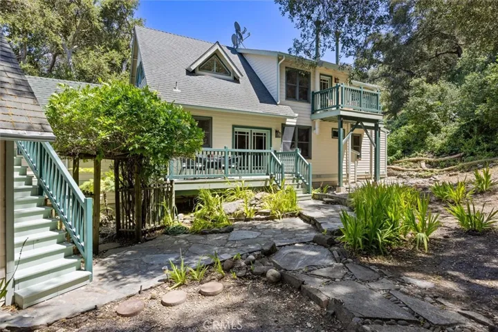 Back deck of main home and stairway to studio apartment