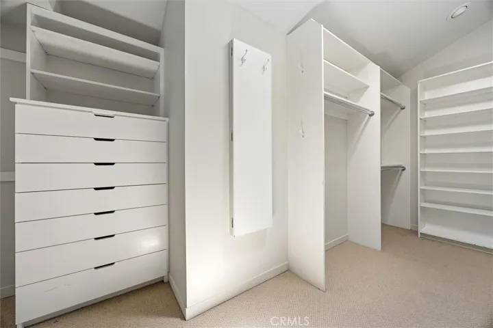 Primary closet with built ins and mirror