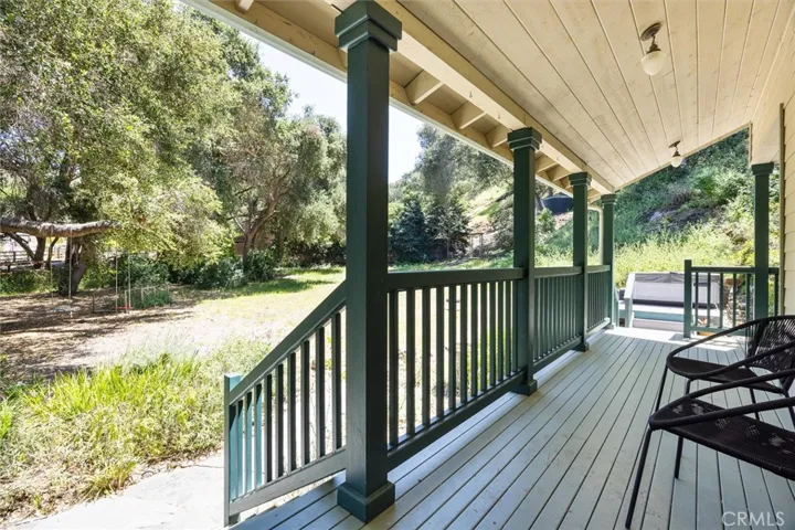 Front porch looks out on flat space- jacuzzi and deck on the right