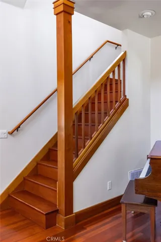 Stairway to second story primary suite, at entry