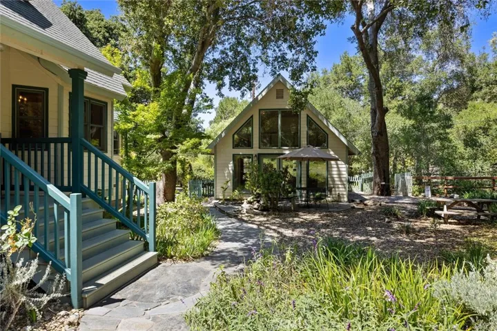 Inviting porch welcomes you to the main house- art studio with multiple windows