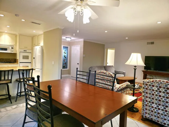 Split View of Dining Area and Kitchen in Evening