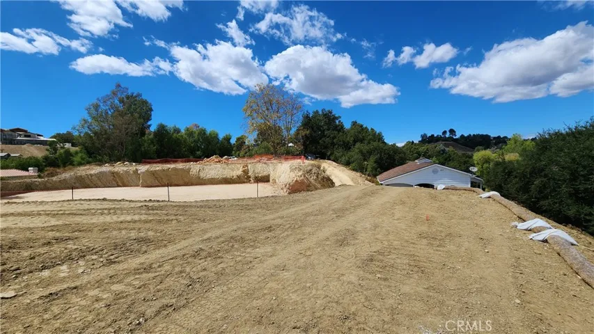 Building pad with the existing barn on the right side, below the pad, with it's own driveway.