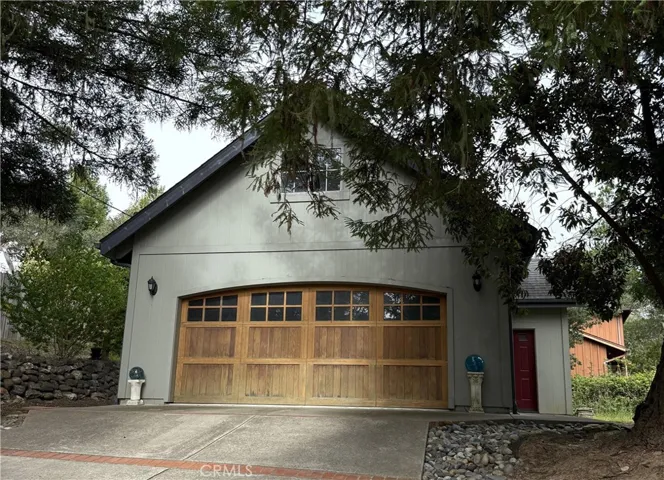 Detached 2 Car Garage has a standing attic above and a storage room