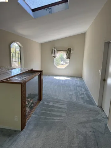 Corridor with a skylight and carpet floors
