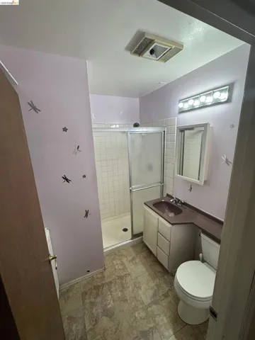 Full bathroom with a stall shower and vanity
