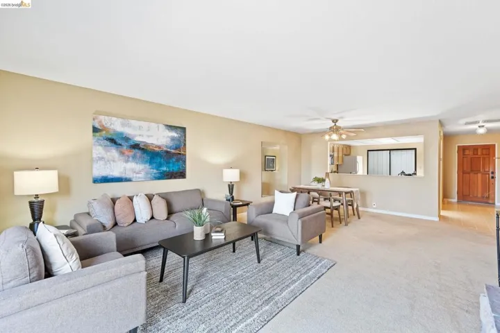 Open-concept living area featuring neutral walls and carpeting