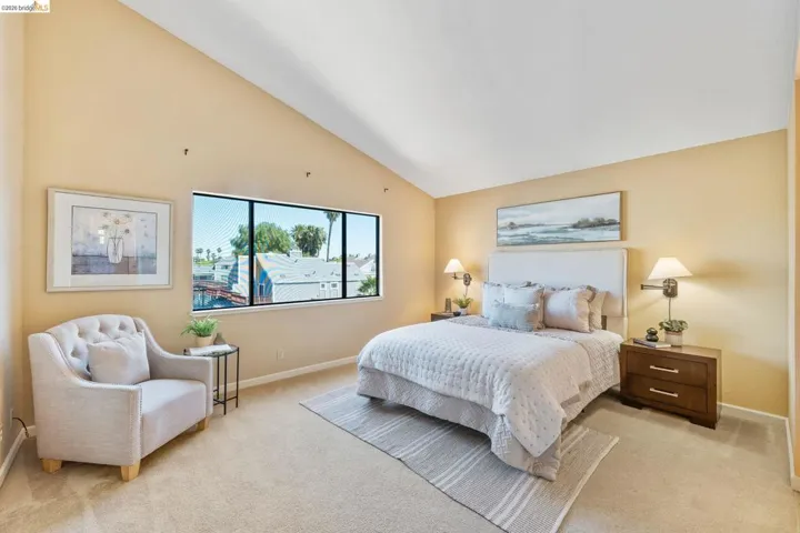 Spacious room with vaulted ceilings and wall-to-wall carpeting
