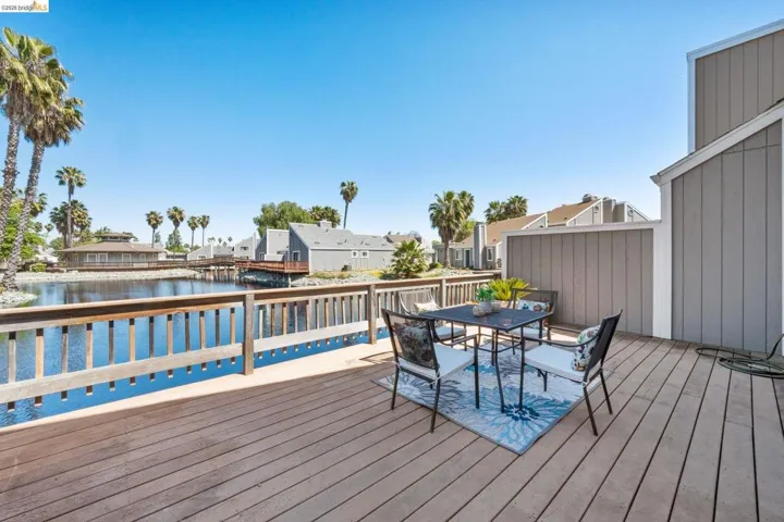 Expansive wood-finish deck overlooking a water feature