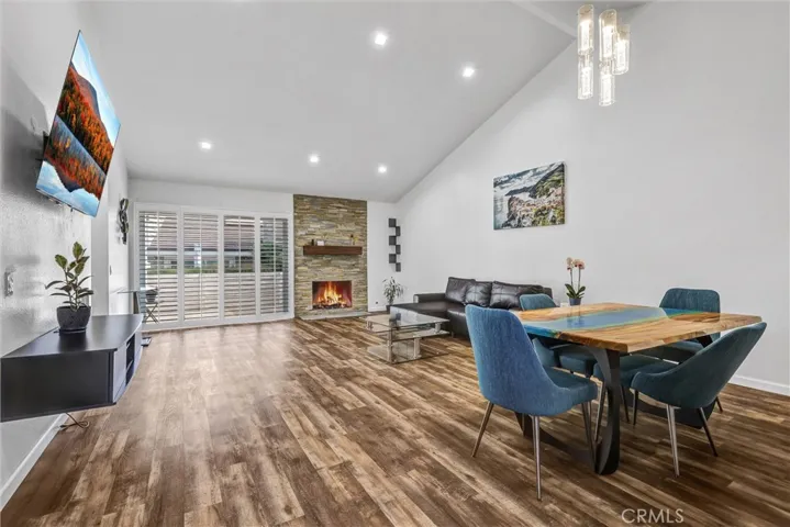 Dining room/living room. Room is staged and is vacant now. Also, fire is virtually enhanced.