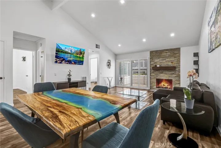 Another view of the dining room and living room staged. TV and fireplace are virtually enhanced.