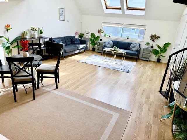 Spacious room featuring wood-finish flooring and sloped ceilings