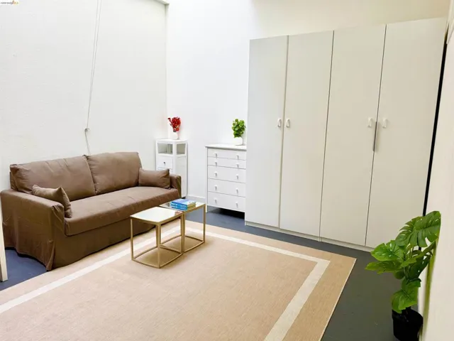 Room featuring white walls and dark flooring