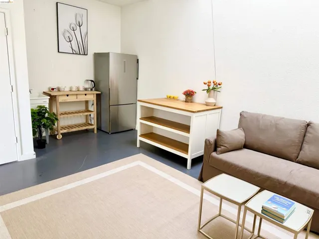 Open concept space featuring grey flooring and white walls