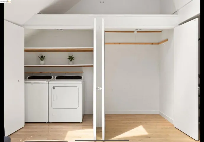 Washroom featuring separate washer and dryer and light wood-type flooring