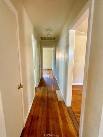 Hallway with hardwood flooring