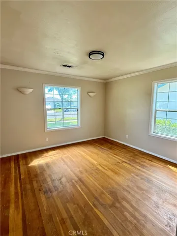 Bedroom 1 with hardwood flooring