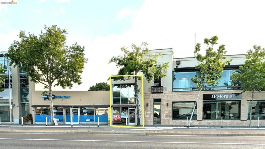 Two-story commercial building featuring a prominent glass storefront