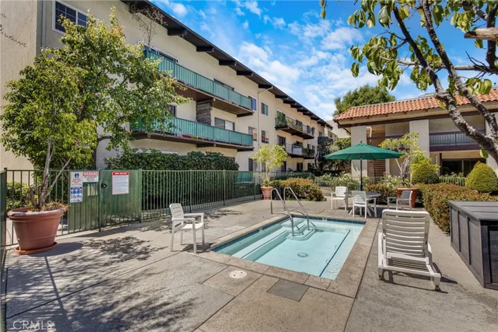 View of the community jacuzzi, well-maintained and ready for relaxation. This amenity is easily accessible from the walking path within the condo grounds.