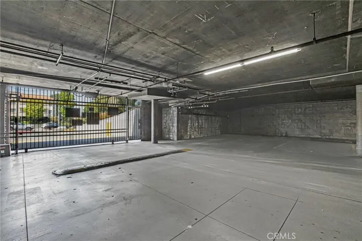 View of the underground parking garage, secured and accessible only via gate key entry. The first-floor unit includes two dedicated parking spaces within this controlled-access garage.