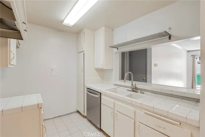 View of the kitchen featuring a convenient passthrough to the adjoining living area. This opening enhances connectivity and makes serving and entertaining effortless.
