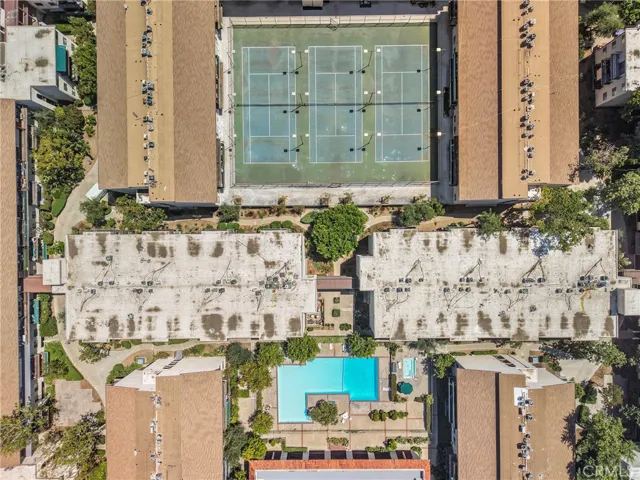 Direct overhead drone view of the condo property, capturing the full footprint of the building and grounds. The shot clearly shows the layout of the community amenities and adjacent spaces.