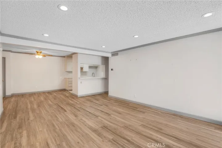 View of the living room area looking toward the kitchen and dining space. The open sightlines create a connected and functional main living area.