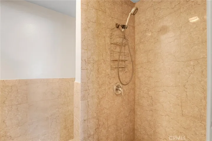 View of the walk-in shower in the secondary bathroom. Simple, clean, and space conscious.