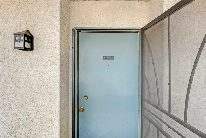 View of the main doorway entrance to the first-floor condo. This entry point welcomes you into the open living space.
