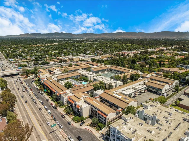 Aerial view of the condo community with the 101 Freeway clearly visible in relation to the property. The image highlights the condo's convenient proximity to major transportation.