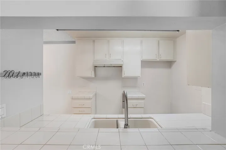 View looking into the kitchen from the passthrough, showcasing the cabinetry. The layout highlights the kitchen's storage and functional workspace.
