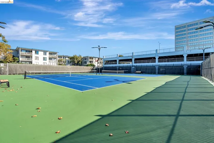 View of tennis court featuring community basketball court