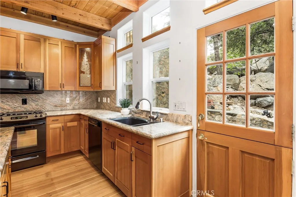 Granite counter tops, natural wood cabinetry and flooring