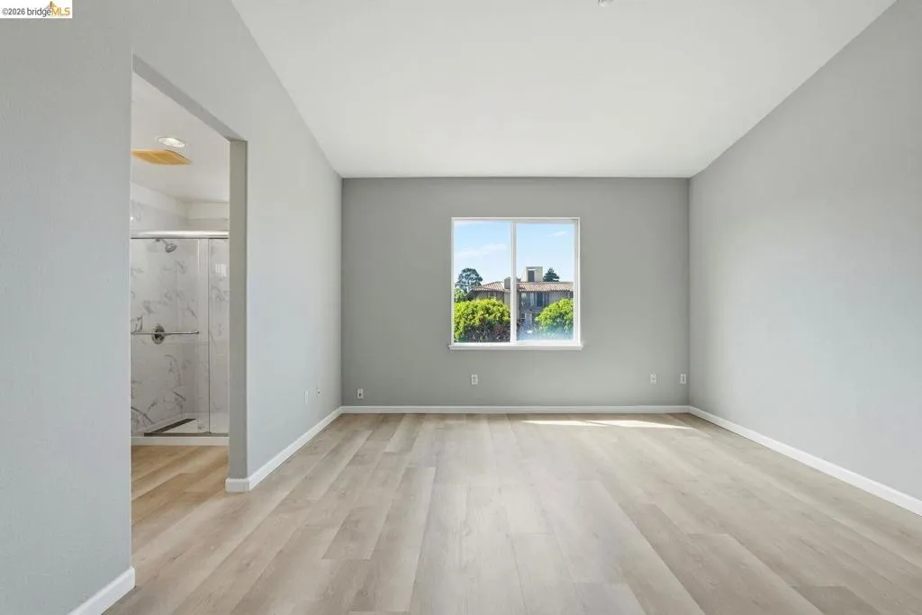 master bathroom featuring light wood-style floors and baseboards