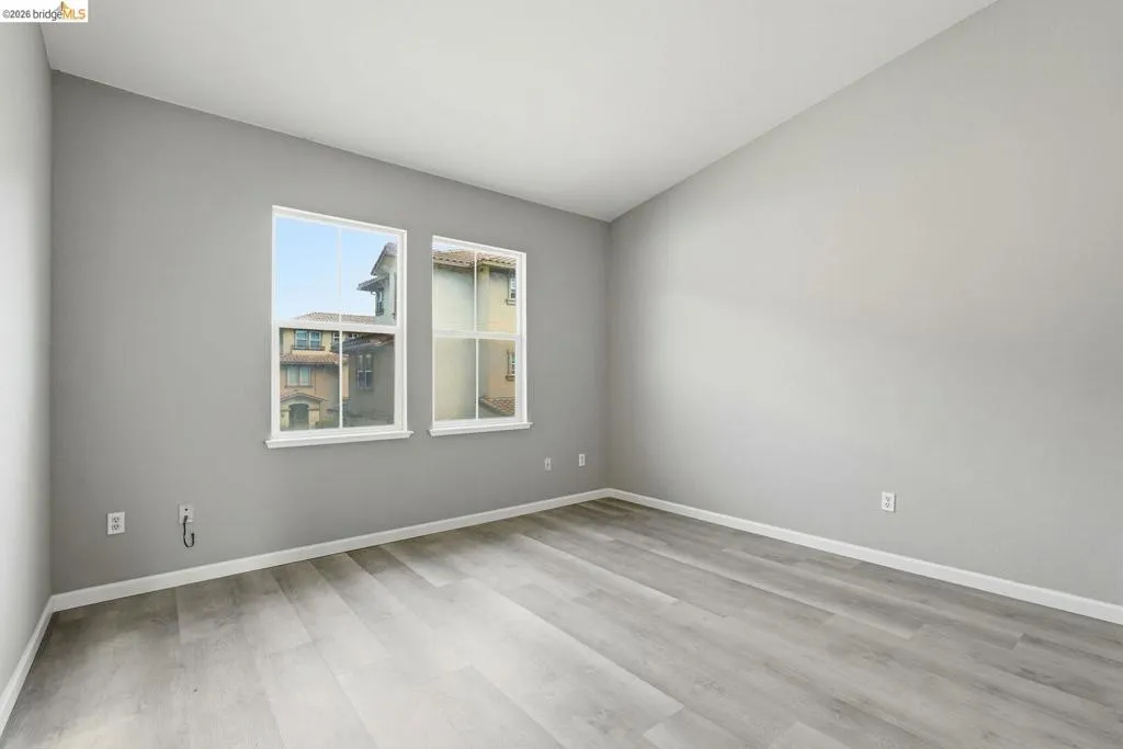 empty room featuring light wood-style flooring and lofted ceiling