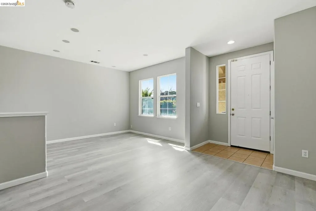 foyer with light wood finished floors and recessed lighting
