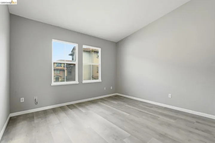 empty room featuring light wood-style flooring and lofted ceiling