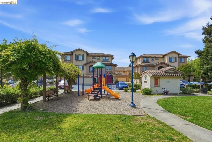 community jungle gym featuring a yard and a residential view
