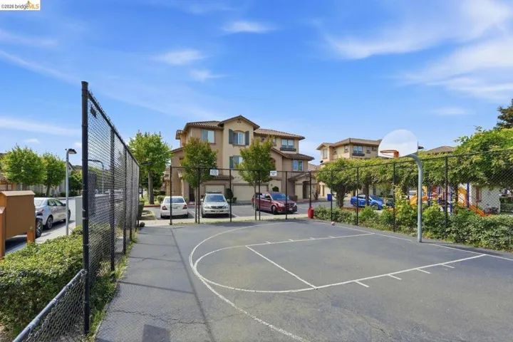 HOA sport court featuring community basketball court and a residential view