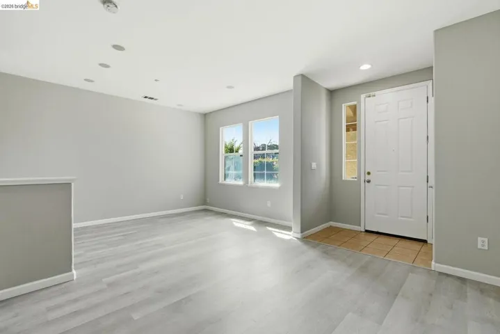 foyer with light wood finished floors and recessed lighting