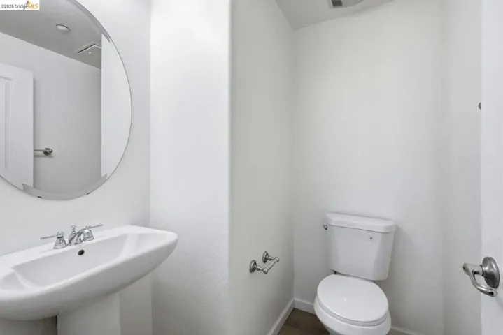 half bathroom with toilet and baseboards
