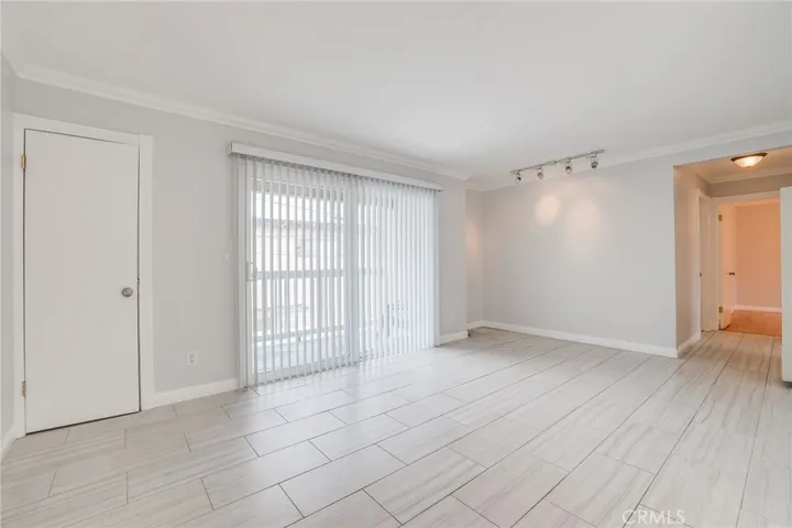 Living Rm view at coat closet and slider to balcony