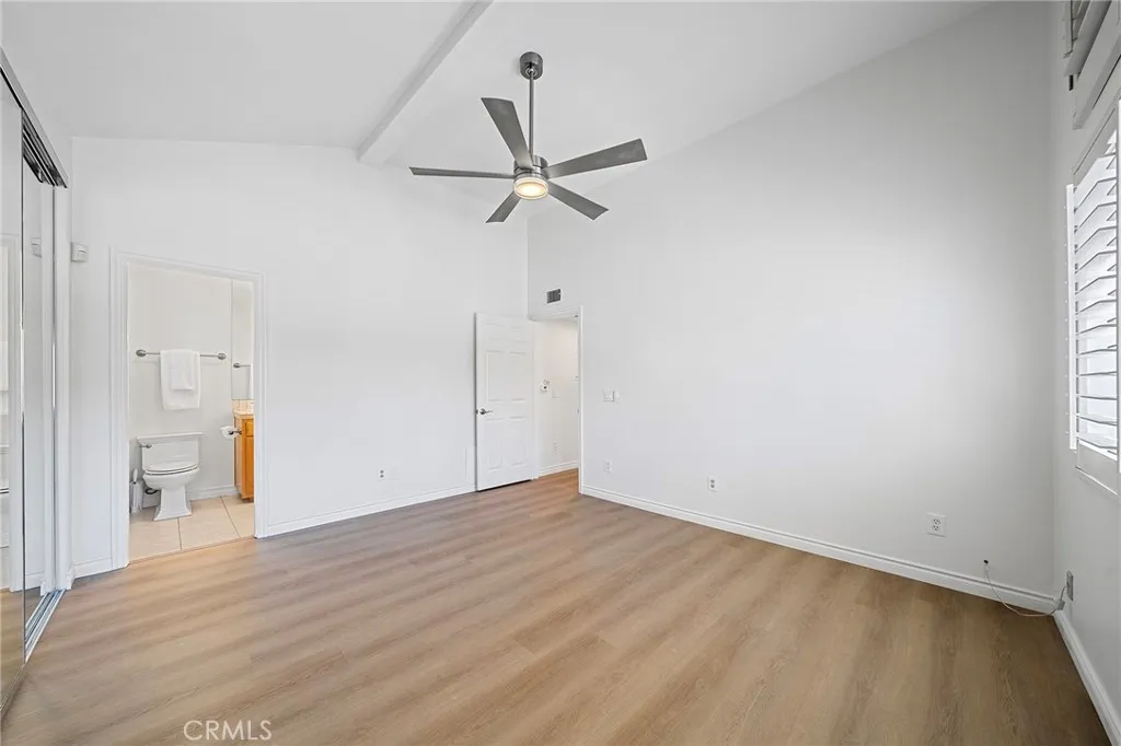Large main suite has an upgraded bathroom and views of the main pool. New floors and new paint. Plantation shutters throughout. Move-in ready.